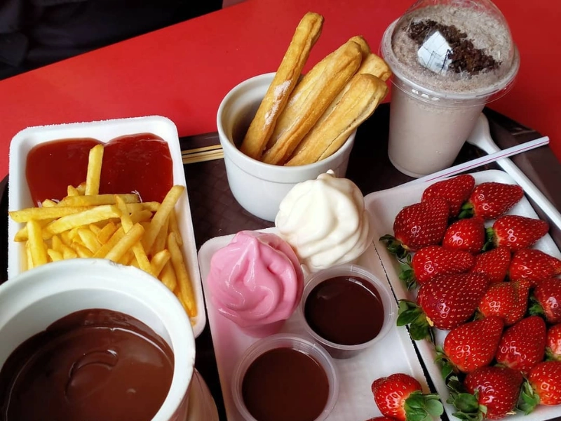 Delicious strawberry ice cream and chocolate fondue at Big Red Strawberry Farm, a sweet local treat your family can enjoy unhurried during your Cameron Highlands day trip.