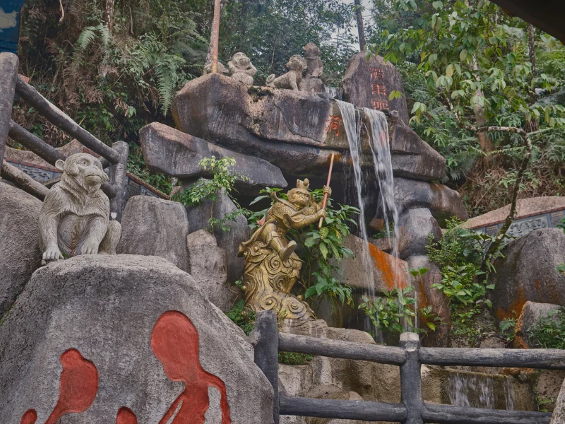 The golden Monkey King statue and waterfall at Chin Swee Caves Temple, a fun family-friendly stop easily visited with your Genting Highlands day trip private car.
