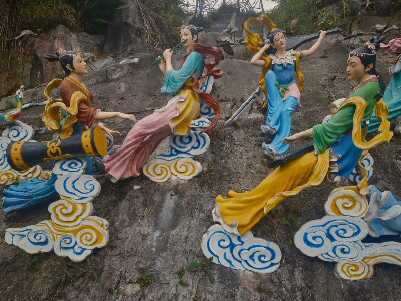 The elegant Seven Fairies statues amidst clouds at Chin Swee Caves Temple, a beautiful cultural landscape you can explore at your own pace with your Genting Highlands day trip private car.