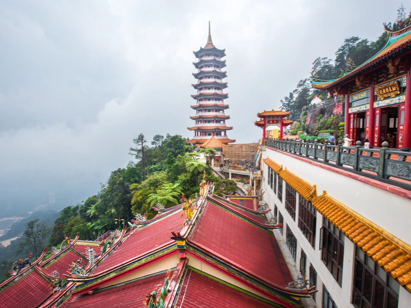The iconic nine-story pagoda at Chin Swee Caves Temple, a majestic mountain landmark you can visit directly and effortlessly on your Genting Highlands day trip private car.
