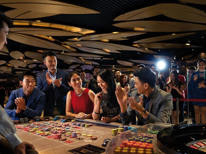 Excited players at a roulette table in SkyCasino Genting Highlands, a world-class entertainment destination best visited with a secure Genting Highlands day trip private car for late-night returns.