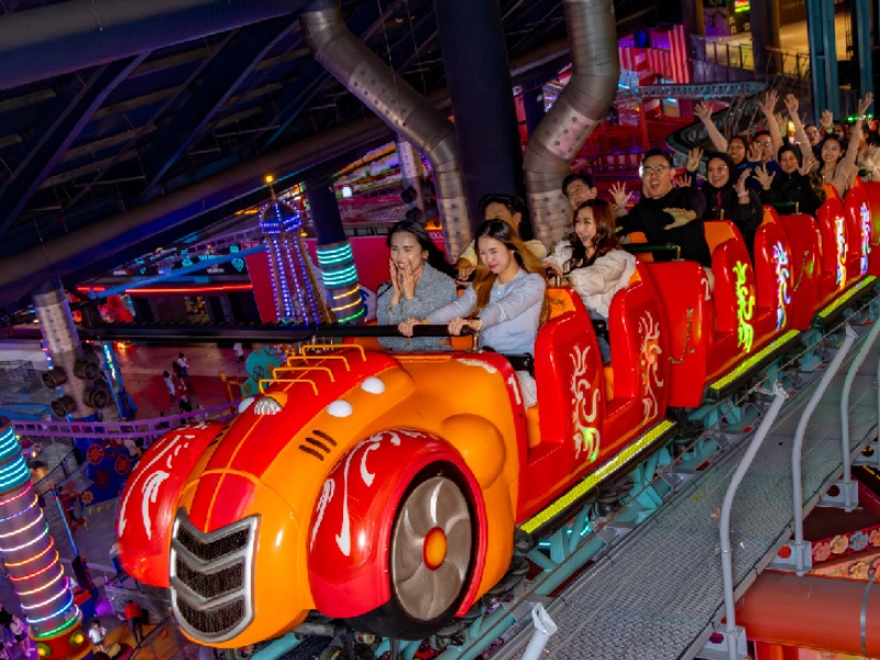 Thrilling red cartoon car-themed indoor coaster at Skytropolis, a popular attraction for tourists using a Genting Highlands day trip private car for a stress-free journey.