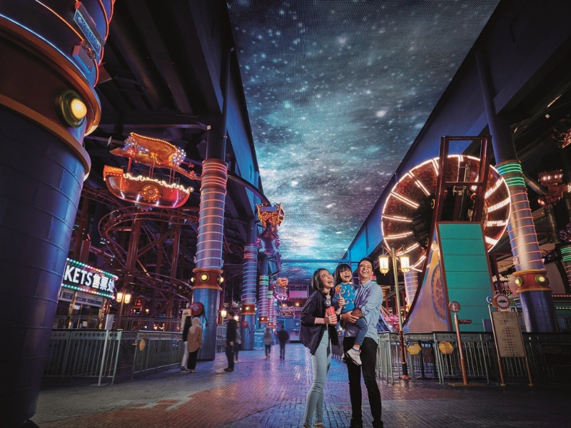 The vibrant neon atmosphere and starry ceiling of Skytropolis Indoor Theme Park, a massive entertainment hub easily navigated with the convenience of your Genting Highlands day trip private car.
