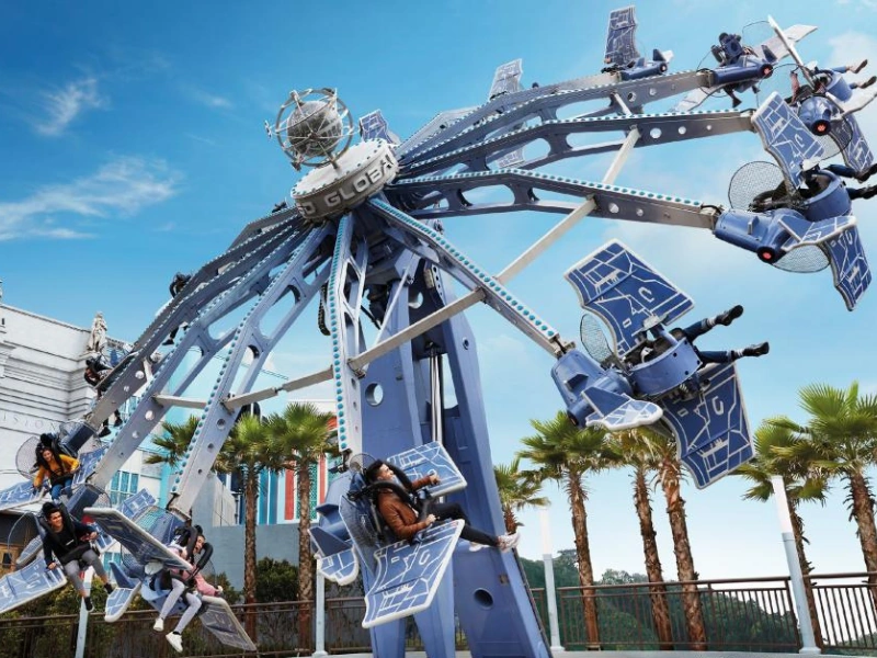 Tourists enjoying the thrilling ESD Global Defender ride at Genting SkyWorlds Theme Park, an exciting attraction best paired with a relaxing ride home in your Genting Highlands day trip private car.