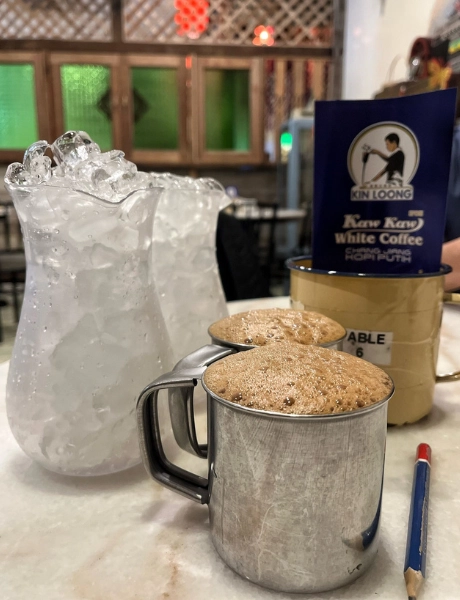 A frothy cup of signature Chang Jiang white coffee, a must-try local cafe experience made easy with convenient drop-offs during your Ipoh day trip.