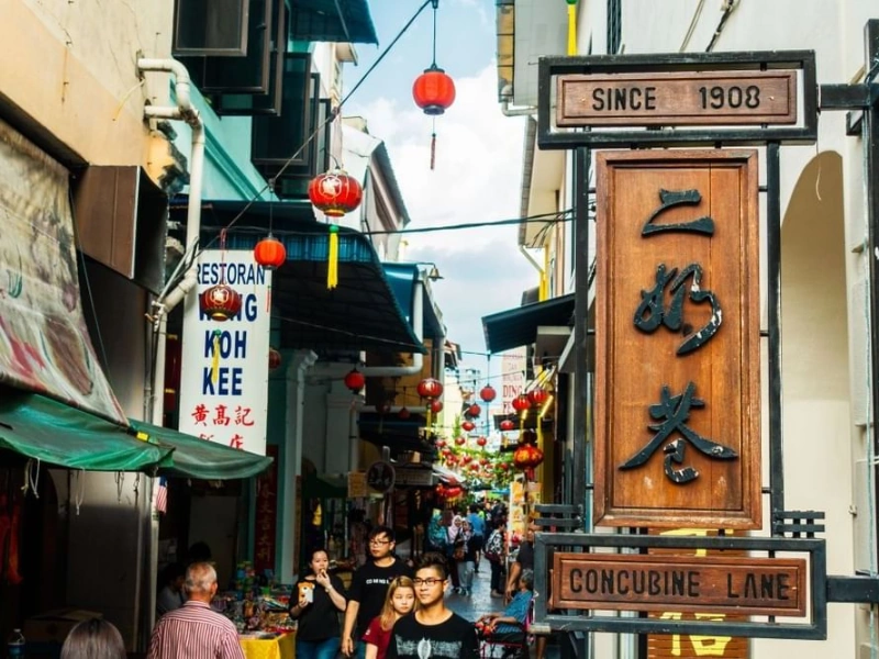 The vibrant red lanterns and heritage shophouses at Concubine Lane, a famous cultural spot you can explore stress-free with convenient drop-offs on your Ipoh day trip.