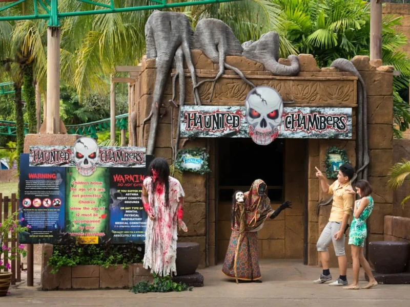 Tourists experiencing thrills at the Haunted Chambers in Lost World of Tambun, a spooky adventure perfectly followed by a safe and calming ride home on your Ipoh day trip.