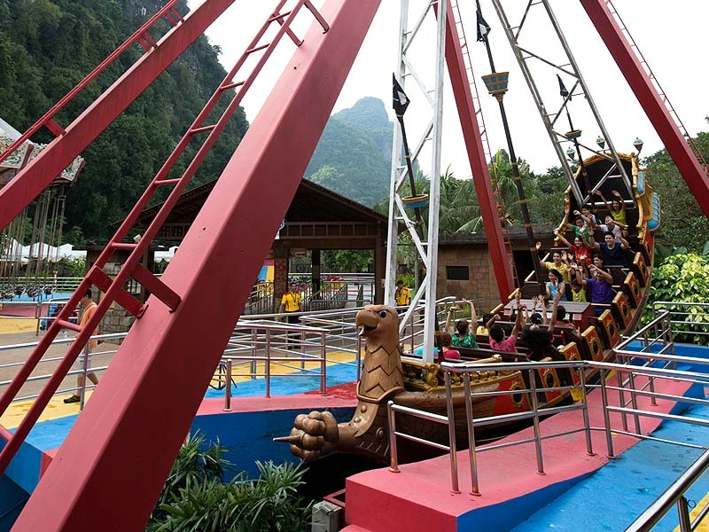Tourists enjoying the thrilling pirate ship ride at Sunway Lost World of Tambun, an exciting adventure you can follow up with a safe and relaxing ride home on your Ipoh day trip.