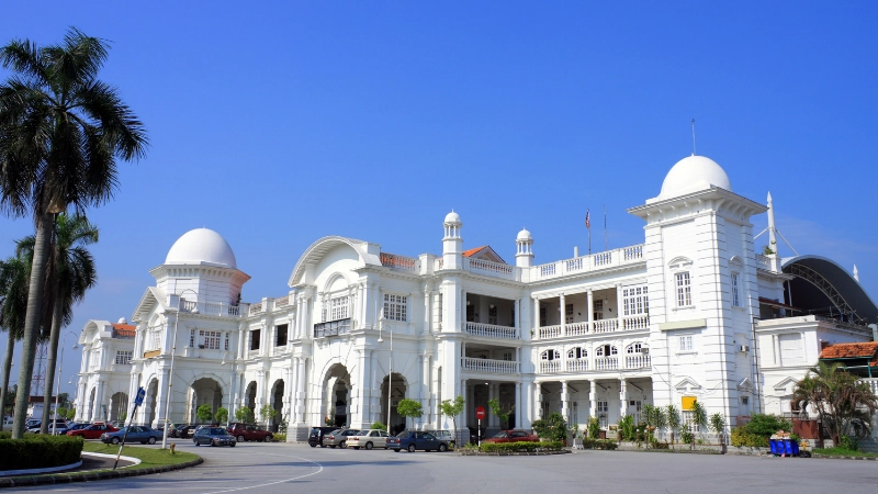 The majestic colonial architecture of Ipoh Railway Station, a stunning historic landmark you can visit effortlessly without transit hassles on your Ipoh day trip.