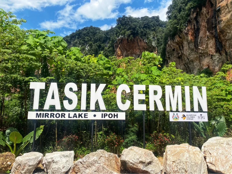 The entrance sign to Tasik Cermin (Mirror Lake), a stunning hidden gem you can easily visit early in the morning on your custom Ipoh day trip.