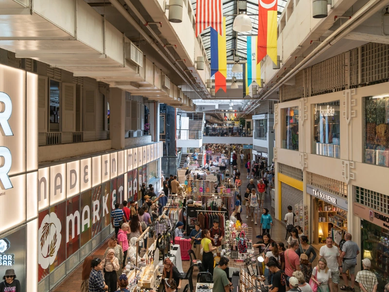 A bustling view of local handicraft stalls and "Made in Malaysia" products inside Central Market, a vibrant cultural shopping stop on your Kuala Lumpur day trip private car tour.