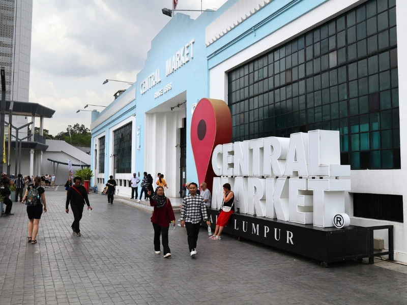 The iconic blue Art Deco facade and landmark sign of Central Market Kuala Lumpur, a top cultural shopping destination for souvenirs on your Kuala Lumpur day trip private car itinerary.