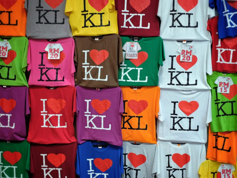 Affordable and colorful "I Love KL" souvenir T-shirts at Central Market, a popular shopping stop included in your Kuala Lumpur day trip private car tour.