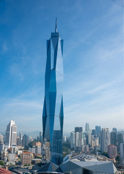 The towering Merdeka 118 skyscraper with its stunning glass facade, an iconic modern landmark to effortlessly visit on your Kuala Lumpur day trip private car tour.