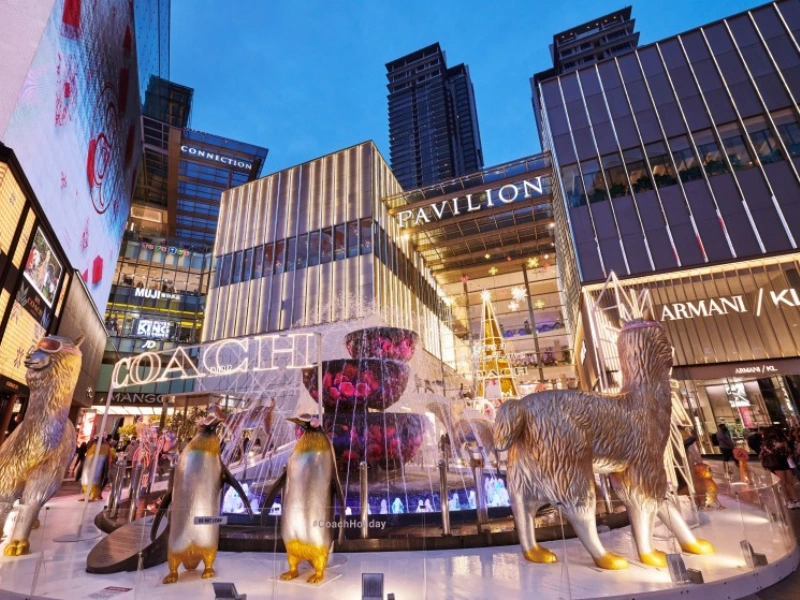 Dazzling festive decorations and lights at the Pavilion KL fountain, a glamorous evening shopping experience to enjoy effortlessly with your Kuala Lumpur day trip private car service.
