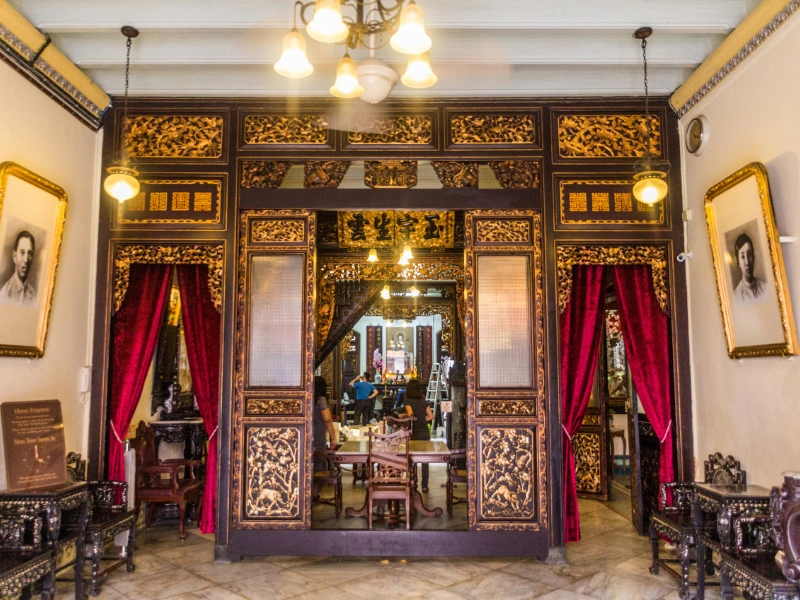 Ornate wooden carvings and traditional main hall of the Baba & Nyonya Heritage Museum, a stunning Peranakan cultural stop during your Malacca day trip private car tour.