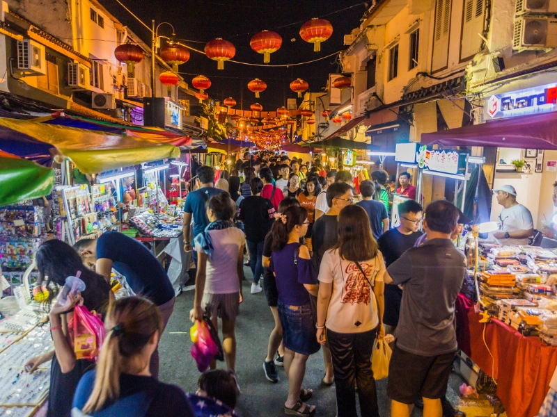 Vibrant crowds and local food stalls at Jonker Walk city center, a must-experience during your custom Malacca day trip private car tour.