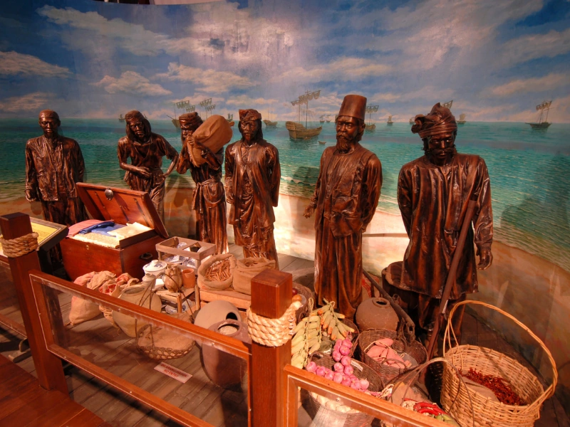 Historical trader statues and maritime exhibits inside the Maritime Museum, an educational discovery during your Malacca day trip private car tour.