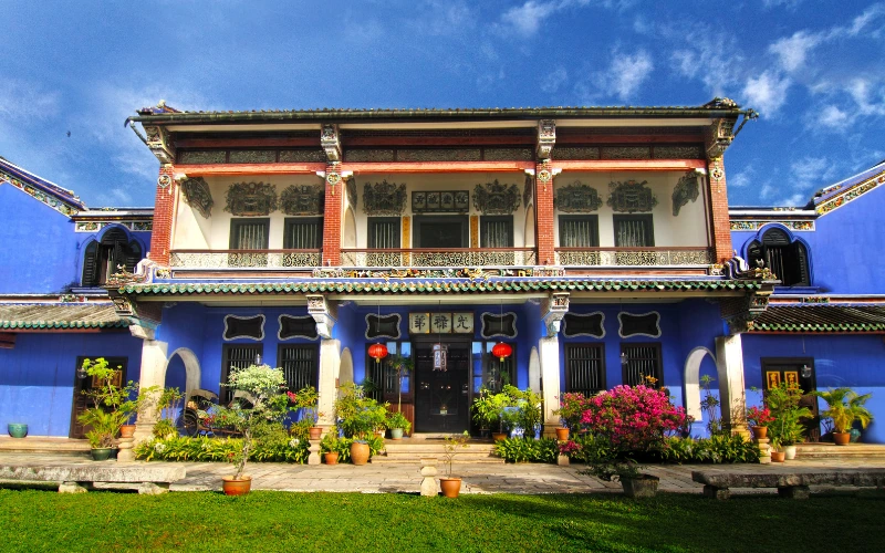The stunning symmetrical facade of the historic Cheong Fatt Tze Blue Mansion, an architectural masterpiece you can reach punctually and stress-free on your Penang Day Trip private car.