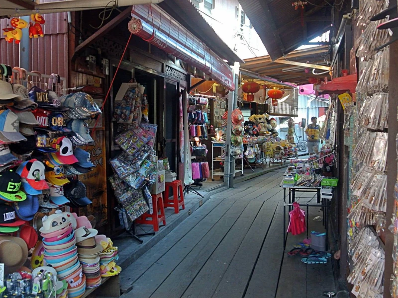 The bustling souvenir street on the wooden boardwalk of Chew Jetty, a vibrant cultural spot you can enjoy without carrying heavy bags on your Penang Day Trip private car.