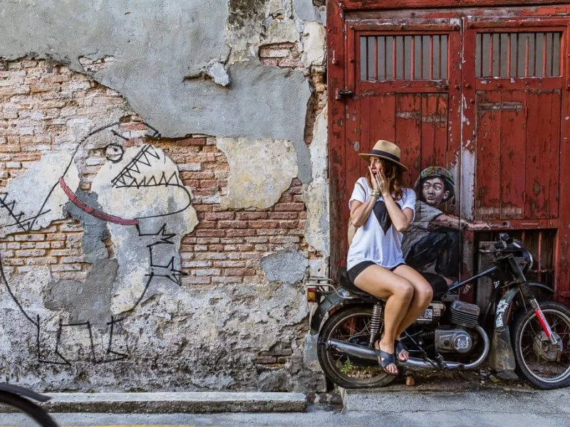 The iconic Boy on Motorcycle 3D mural in Georgetown, an interactive art piece you can comfortably hop out and snap without walking in the heat on your Penang Day Trip private car tour.