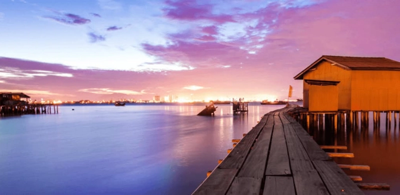 Historic wooden stilt houses of the Clan Jetties in Georgetown, a fascinating coastal heritage you can visit without heat and parking stress on your Penang Day Trip private car.