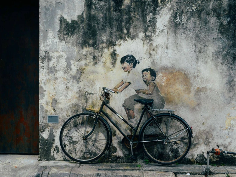 The famous Kids on Bicycle mural in Georgetown, an iconic interactive art piece you can visit easily without parking hassle on your Penang Day Trip private car tour.