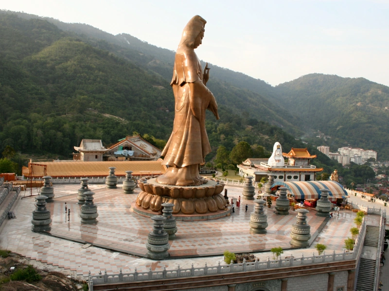 The giant bronze Guanyin statue at Kek Lok Si Temple, a majestic spiritual site you can reach effortlessly on your Penang Day Trip by private car.