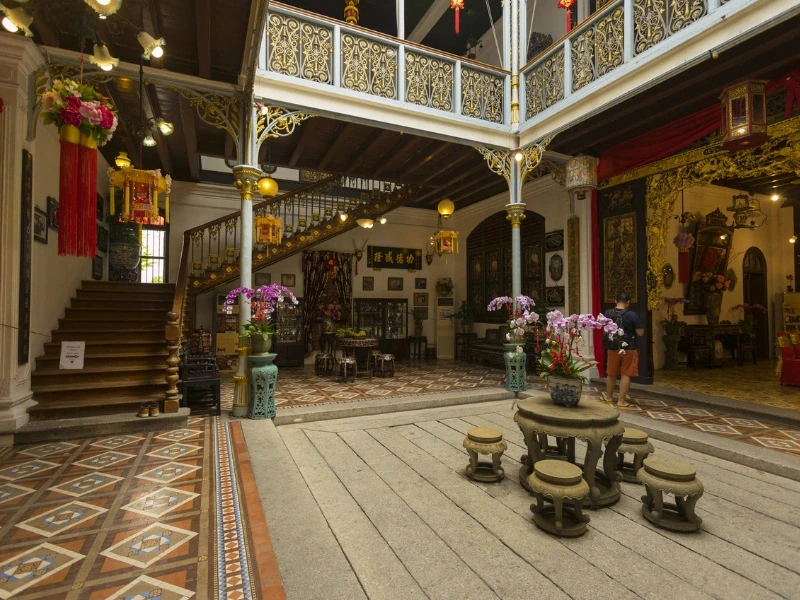 The elegant interior courtyard of Pinang Peranakan Mansion, a stunning Baba Nyonya museum you can discover effortlessly without parking worries on your Penang Day Trip private car.