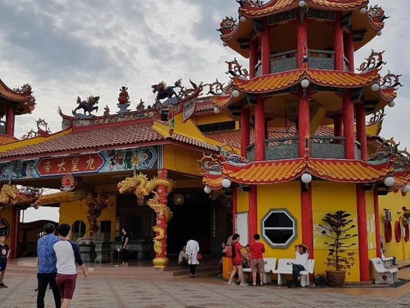 The vibrant yellow and red architecture of Nan Tian Temple, a stunning landmark easily accessible for elderly family members when traveling in your comfortable Sekinchan day trip private car.