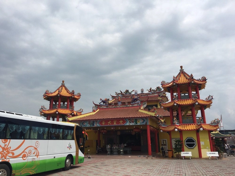Scenic view of the colorful Nan Tian Temple surrounded by lush green fields, easily reached with our experienced drivers on your Sekinchan day trip private car tour.