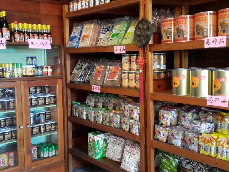 Traditional biscuits and childhood snacks at a retro grocery store, a great place to buy bulky souvenirs with zero luggage hassle using your Sekinchan day trip private car.